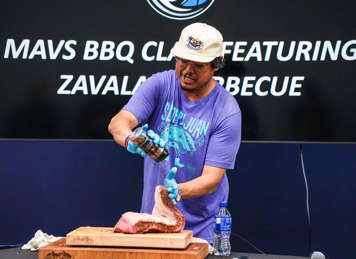 Pitmaster Joe Zavala seasoning a brisket at a Zavala's Barbecue class